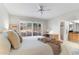 Bright main bedroom featuring white walls, a ceiling fan, and a desk with window views at 7912 E Plaza Ave, Scottsdale, AZ 85250