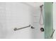 Modern shower with white subway tile, grab bar, and multi-setting shower head at 7912 E Plaza Ave, Scottsdale, AZ 85250