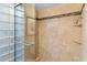 Nicely tiled shower with glass block window and decorative tile accent border at 7912 E Plaza Ave, Scottsdale, AZ 85250