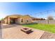 Expansive backyard features a patio, fire pit, and low-maintenance artificial turf at 828 W Leadwood Ave, San Tan Valley, AZ 85140