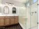 Modern bathroom with double vanity, a glass-enclosed shower and black tile floor at 828 W Leadwood Ave, San Tan Valley, AZ 85140