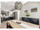 Open dining room with decorative lighting adjacent to the kitchen features modern furnishings and decor at 828 W Leadwood Ave, San Tan Valley, AZ 85140