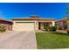 Charming single-story home with a well-manicured lawn, brick driveway, and welcoming facade at 828 W Leadwood Ave, San Tan Valley, AZ 85140