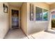 Inviting front porch area with a decorative welcome sign, a wreath, and a black front door at 828 W Leadwood Ave, San Tan Valley, AZ 85140