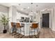 Open kitchen area features a breakfast bar with pendant lighting and views of the front entry door at 828 W Leadwood Ave, San Tan Valley, AZ 85140