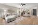 Open-concept living room with lots of natural light features a sectional sofa and wood-look floors at 828 W Leadwood Ave, San Tan Valley, AZ 85140