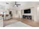 Bright living room offers an open floor plan with modern ceiling fan and sightlines to kitchen breakfast bar at 828 W Leadwood Ave, San Tan Valley, AZ 85140