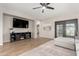 Spacious living area with wood-look floors offers sightlines to the backyard through the dining area doors at 828 W Leadwood Ave, San Tan Valley, AZ 85140