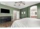 View of a the main bedroom including a dresser, tv, and ensuite bath at 828 W Leadwood Ave, San Tan Valley, AZ 85140