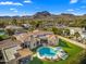 Stunning aerial view of home with pool, lush lawn, and mountain views at 8315 N Sendero Tres M --, Paradise Valley, AZ 85253