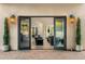 Backyard view into the home, featuring french doors, sleek outdoor lighting, and lush green trees at 8315 N Sendero Tres M --, Paradise Valley, AZ 85253