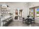 Casual dining area next to kitchen features modern light fixture and view of formal dining and back yard at 8315 N Sendero Tres M --, Paradise Valley, AZ 85253