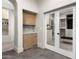 Hallway with a built-in cabinet and glass door access to a custom-built closet at 8315 N Sendero Tres M --, Paradise Valley, AZ 85253