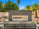 Backyard features an outdoor fireplace with comfortable seating, set against desert landscaping with citrus trees and mountain views at 8315 N Sendero Tres M --, Paradise Valley, AZ 85253