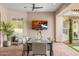 Outdoor covered dining area with patio furniture and a TV and an artificial plant wall at 8315 N Sendero Tres M --, Paradise Valley, AZ 85253