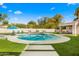 Backyard with a turquoise pool, adjacent spa, lush landscaping and green lawn at 8315 N Sendero Tres M --, Paradise Valley, AZ 85253