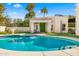 Backyard with a turquoise pool, lush landscaping, pool house and palm trees at 8315 N Sendero Tres M --, Paradise Valley, AZ 85253