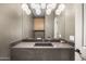 Stylish powder room featuring a floating cabinet, dark quartz countertop, and modern mirror at 8315 N Sendero Tres M --, Paradise Valley, AZ 85253