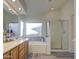 Bathroom featuring double sinks, a soaking tub, and a separate shower at 835 W Beechnut Dr, Chandler, AZ 85248