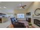 Cozy living room with fireplace, comfortable seating, and view of backyard pool at 835 W Beechnut Dr, Chandler, AZ 85248