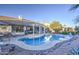 A serene backyard pool with a covered patio and desert landscaping creates an inviting outdoor living space at 835 W Beechnut Dr, Chandler, AZ 85248