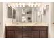 Bathroom with a double sink vanity with dark cabinets and large mirrors at 855 E Vaughn Ave, Gilbert, AZ 85234