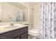 Clean bathroom featuring a shower-tub combo, vanity with sink, and neutral-toned decor at 855 E Vaughn Ave, Gilbert, AZ 85234