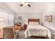 Bedroom with neutral walls, ceiling fan, an upholstered chair, and a floral quilt on the bed at 855 E Vaughn Ave, Gilbert, AZ 85234