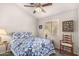 Bedroom with a blue floral quilt on the bed, neutral walls, and a window at 855 E Vaughn Ave, Gilbert, AZ 85234