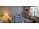 Cozy bedroom featuring a quilt-covered bed with star patterned pillows and side tables with lamps at 855 E Vaughn Ave, Gilbert, AZ 85234