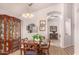 Charming dining area featuring wood-look floors, ornate china cabinet, and stylish lighting fixtures at 855 E Vaughn Ave, Gilbert, AZ 85234