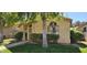 Single story home with desert landscaping, arched windows and a covered entry way at 855 E Vaughn Ave, Gilbert, AZ 85234