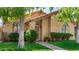 Welcoming single-story home features an arched entryway, neat landscaping, and a green lawn at 855 E Vaughn Ave, Gilbert, AZ 85234