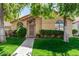 Charming single-story home featuring lush landscaping, a secure front door, and a well-manicured lawn at 855 E Vaughn Ave, Gilbert, AZ 85234