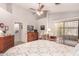 Spacious bedroom featuring a ceiling fan, natural light, and a dresser near a sliding door at 855 E Vaughn Ave, Gilbert, AZ 85234