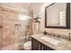 Well-lit bathroom with a modern shower, granite countertop vanity, and decorative mosaic tile accents at 8632 E Gail Rd, Scottsdale, AZ 85260