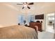 Bedroom featuring a bed, dresser, and a ceiling fan at 8632 E Gail Rd, Scottsdale, AZ 85260