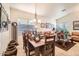 Open dining room with dark wood table, adjacent to a comfortable leather sofa and decorative accents at 8632 E Gail Rd, Scottsdale, AZ 85260