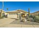 Charming single-story home featuring desert landscaping, an attached garage, and a welcoming front entrance at 8632 E Gail Rd, Scottsdale, AZ 85260