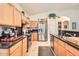 Well-lit kitchen featuring stainless steel appliances, granite countertops, and wood cabinetry at 8632 E Gail Rd, Scottsdale, AZ 85260