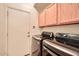 Efficient laundry room equipped with a modern washer and dryer set and ample cabinet space at 8632 E Gail Rd, Scottsdale, AZ 85260