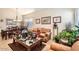 Inviting living room with a comfortable leather couch, a dark wood dining table, and plenty of natural light at 8632 E Gail Rd, Scottsdale, AZ 85260