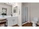 Bathroom featuring a walk-in shower, toilet, and vanity with a modern sink at 9019 W Acoma Dr, Peoria, AZ 85381