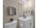 Well-lit bathroom features a single sink vanity, large mirror, and a neutral color scheme at 9019 W Acoma Dr, Peoria, AZ 85381