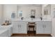 Bright bathroom featuring dual sinks, vanity space, and modern fixtures at 9019 W Acoma Dr, Peoria, AZ 85381