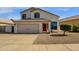 Two-story home featuring a two car garage, red front door, and manicured landscaping at 9019 W Acoma Dr, Peoria, AZ 85381