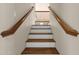 Staircase with wooden railings and alternating white and wood treads leading to the upper level at 9019 W Acoma Dr, Peoria, AZ 85381