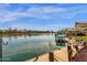 View of a backyard waterfront dock and relaxing lake view from the backyard at 9019 W Acoma Dr, Peoria, AZ 85381