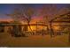 Spacious backyard with mature trees, desert landscaping, and a rustic patio area at 9031 N 14Th St, Phoenix, AZ 85020