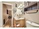 The bathroom with a wooden vanity, shelving, mirror, toilet, and neutral paint at 9031 N 14Th St, Phoenix, AZ 85020